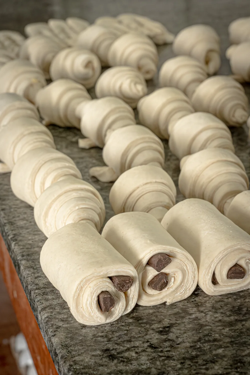 Hand-shaped artisan cornetti before baking